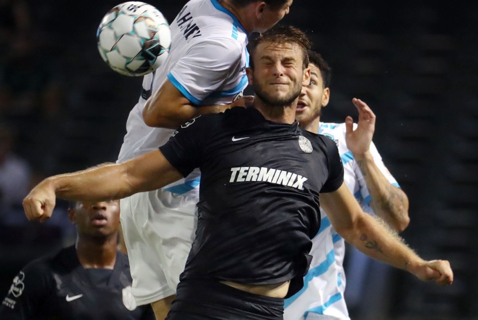 <strong>Memphis 901 FC defender Zach Carroll (3) goes up for a header over a Colorado Springs defender during a Aug. 10, 2021 home match at AutoZone Park.</strong> (Patrick Lantrip/Daily Memphian file)
