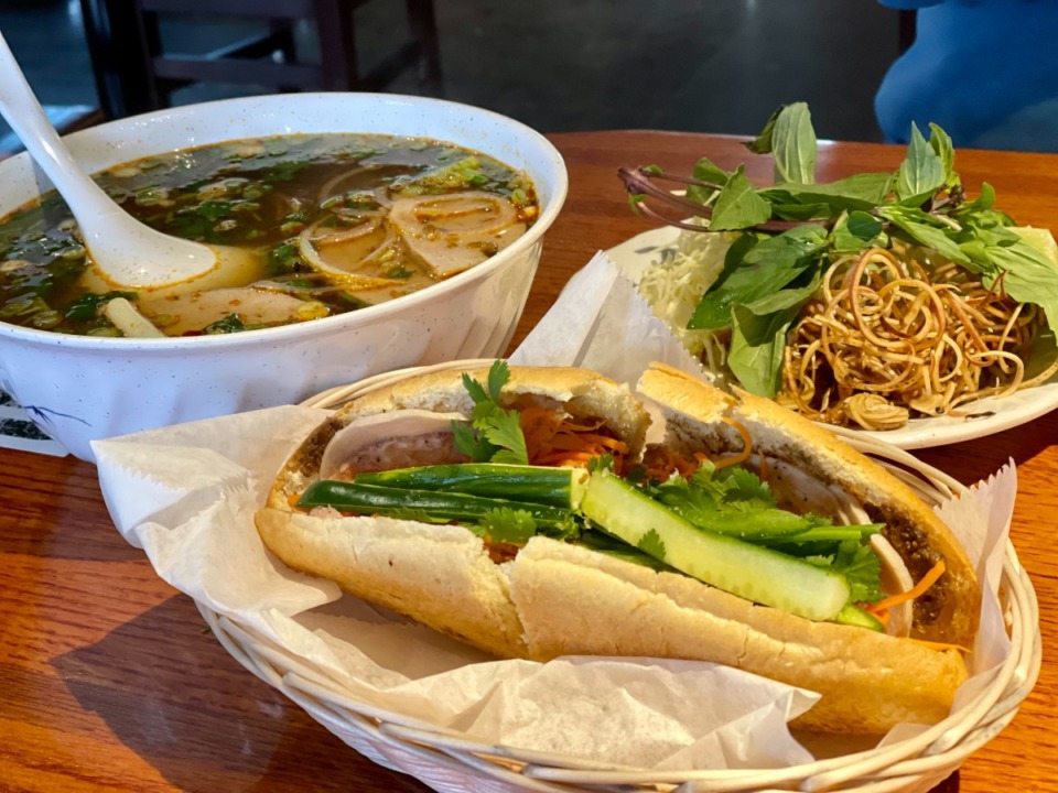 <strong>Bun bo Hue comes with a plate of add-ins that include shaved curls of banana flower; the banh mi is a traditional Vietnamese sandwich.</strong> (Jennifer Biggs/The Daily Memphian)