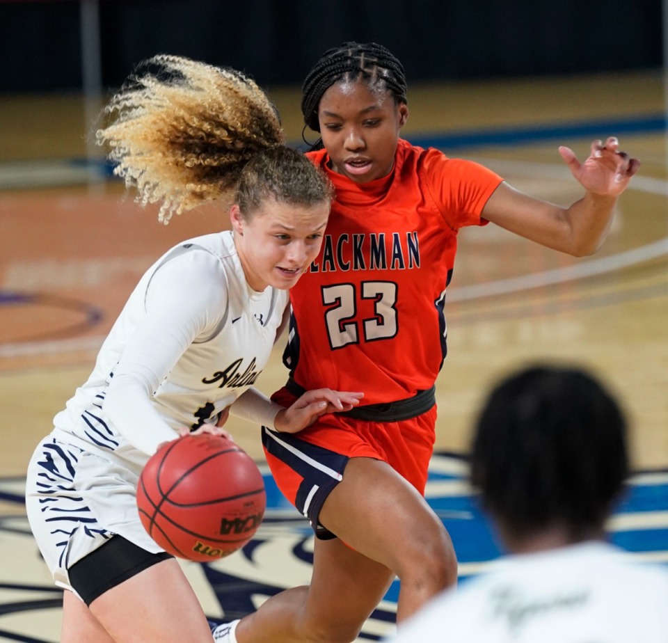 <strong>Alindsey Long (left) tries to get by Iyana Moore (23) as Arlington plays Blackman at the Division I Class AAA quarterfinal game during TSSAA girls basketball state tournament at Middle Tennessee State University on March 11, 2021, in Murfreesboro.</strong> (Courtesy of Larry McCormack)