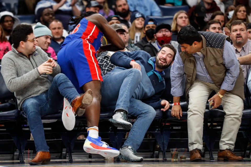 <strong>Grizzlies fans duck out of the way of diving Detroit Pistons defender Isaiah Stewart (middle) on Thursday, Jan. 6, 2022.</strong> (Mark Weber/The Daily Memphian)