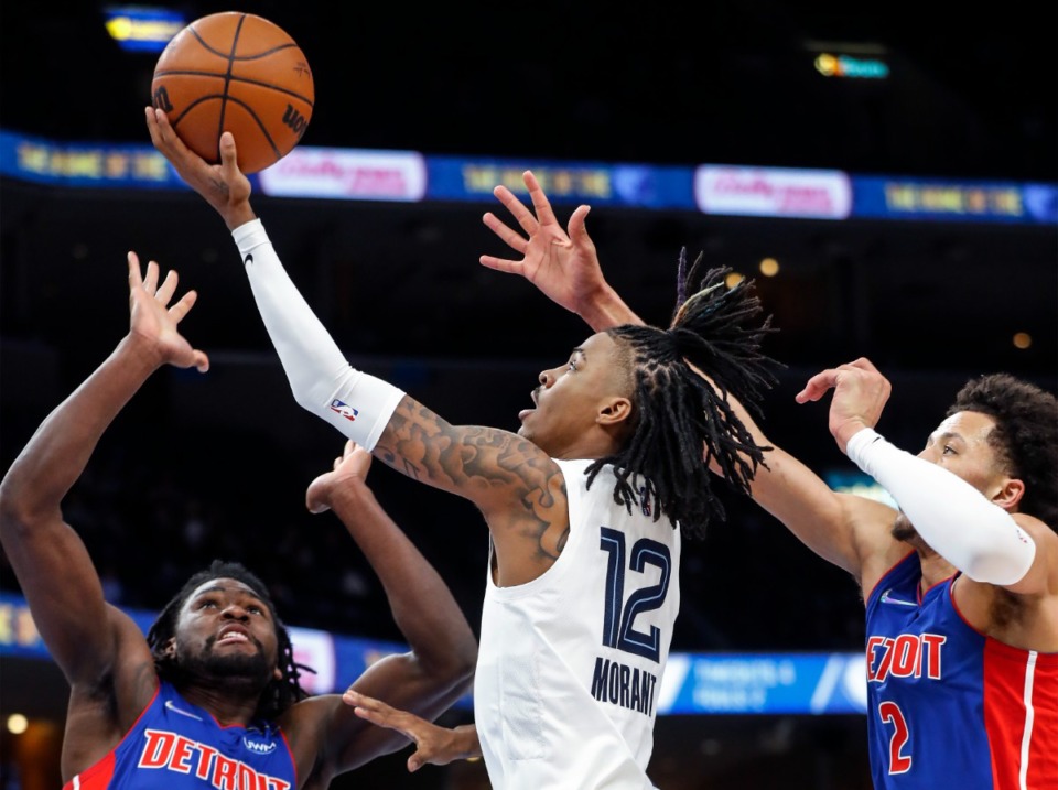 <strong>Memphis Grizzlies guard Ja Morant (middle) drives for a layup against Detroit Pistons defenders Isaiah Stewart (left) and Cade Cunningham (right) during action on Thursday, Jan. 6, 2022.</strong> (Mark Weber/The Daily Memphian)