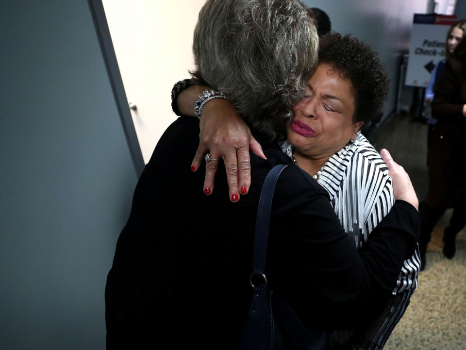 <strong>Jan Taylor, program director of Baptist Operation Outreach, hugs a friend while celebrating the opening of the new Baptist Operation Outreach Clinic. The outreach program provides a free mobile health clinic for individuals and families without permanent housing.</strong> (Houston Cofield/Daily Memphian)