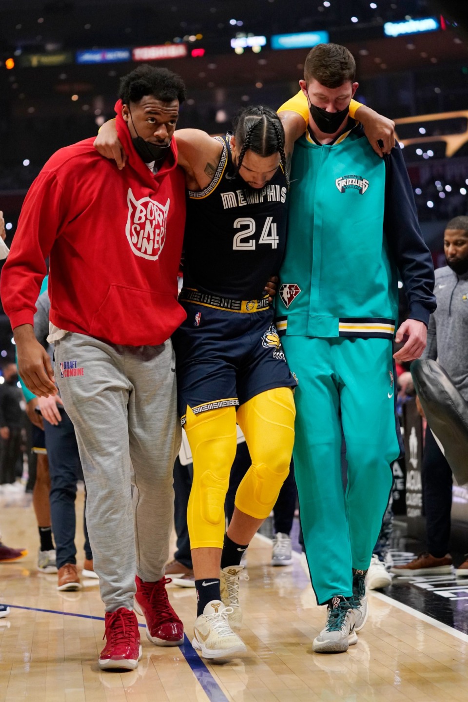 <strong>Memphis Grizzlies forward Dillon Brooks, center, is helped off the court by teammates after injuring himself during the first half of an NBA basketball game against the Los Angeles Clippers Saturday, Jan. 8, 2022, in Los Angeles.</strong> (AP Photo/Mark J. Terrill)