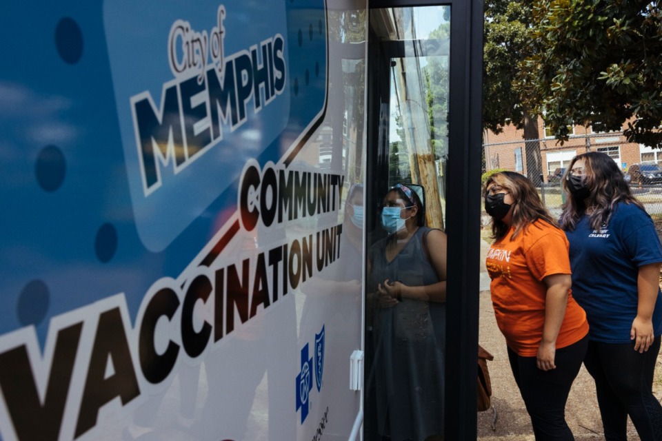 <strong>Members of the Gonzales family (mother Aracely, left), Areli and Andrea) enter mobile community vaccination unit to receive their choice of COVID vaccine at Carpenter Art Garden in Binghampton on Aug. 12, 2021. Shelby County is now at a 50% vaccination rate.</strong> (Ziggy Mack/The Daily Memphian file)