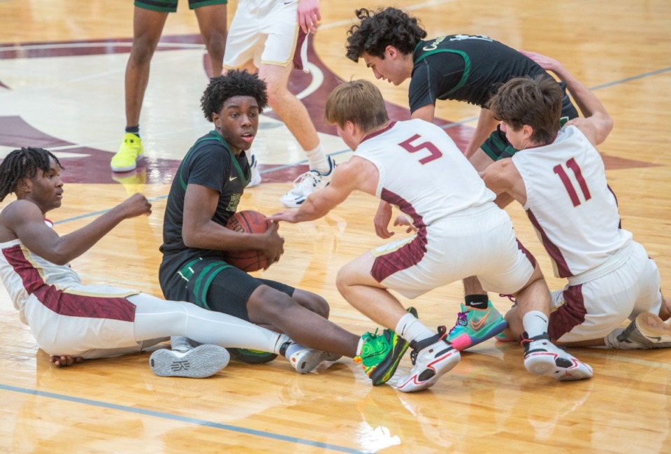<strong>FACS' TJ Thomas struggles to pass the ball as a host of ECS players surrounds him on Jan. 11 at ECS. FACS came from behind to win in overtime 56-47.</strong> (Greg Campbell/Special to The Daily Memphian)