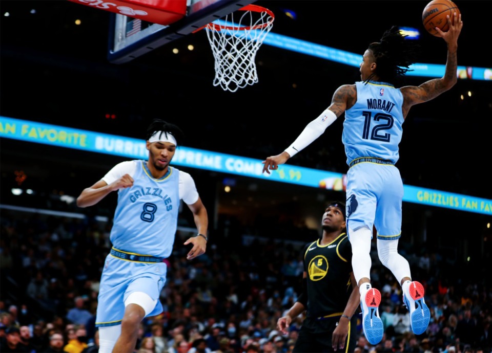 <strong>Grizzlies guard Ja Morant (12) throws down a dunk after a lob from Ziaire Williams (8) on Jan. 11, 2022, in the game against the Golden State Warriors at FedExForum.</strong> (Patrick Lantrip/Daily Memphian)