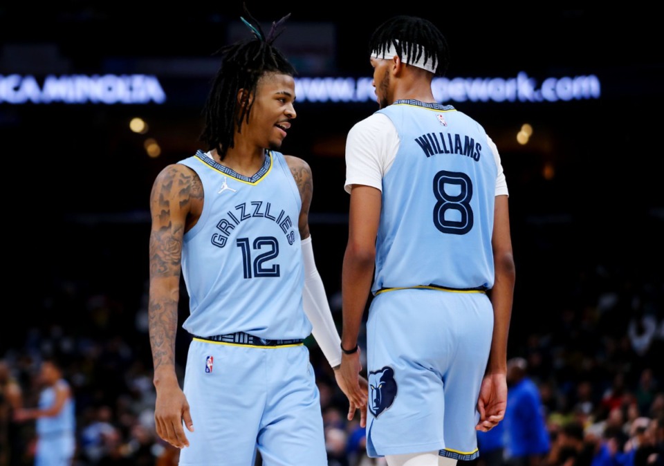 <strong>Grizzlies guard Ja Morant (12) shakes hands with Ziaire Williams (8) during the Jan. 11 game against the Golden State Warriors at FedExForum.</strong> (Patrick Lantrip/Daily Memphian)