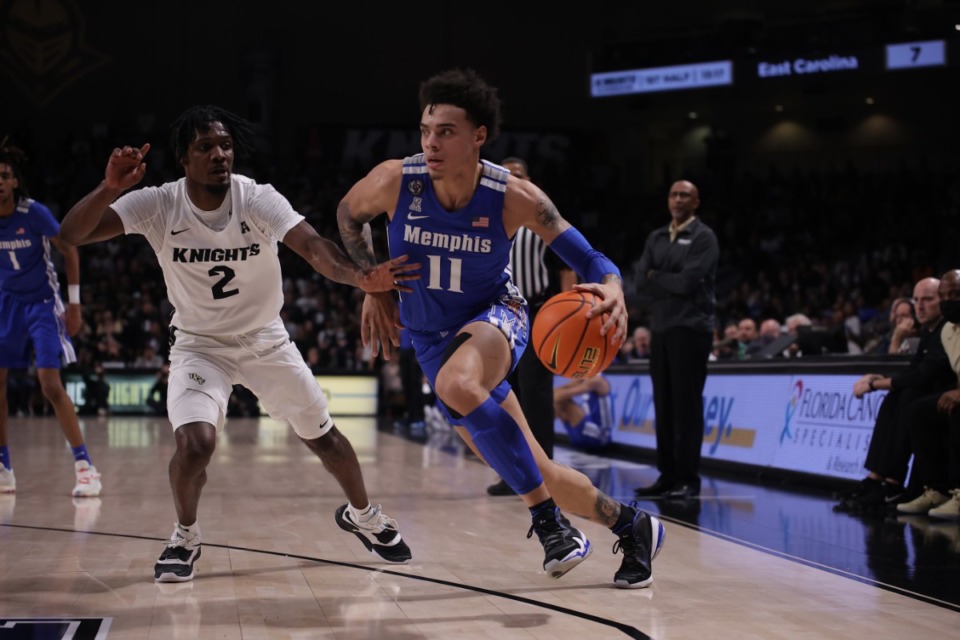 <strong>Memphis Tigers guard Lester Quinones (11) dribbles past UCF&rsquo;s Darius Perry (2) in Florida on Jan. 12. He is one of the few healthy Tigers.</strong> <strong>Quinones was a game-time decision after getting banged-up in practice.</strong> (Courtesy UCF Athletics)