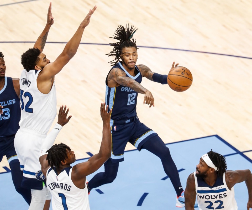 <strong>Grizzlies guard Ja Morant (middle) makes a pass against the Minnesota Timberwolves on Thursday, Jan. 13, 2022.</strong> (Mark Weber/The Daily Memphian)