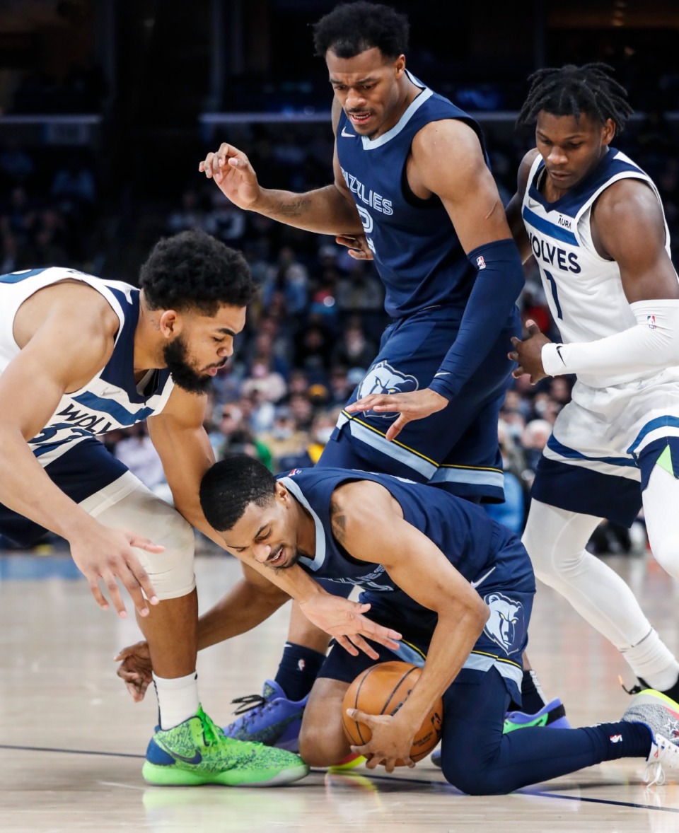 <strong>Grizzlies guard De'Anthony Melton (middle bottom) battles Minnesota&rsquo;s Karl-Anthony Towns (left) for a loose ball on Thursday, Jan. 13, 2022.</strong> (Mark Weber/The Daily Memphian)