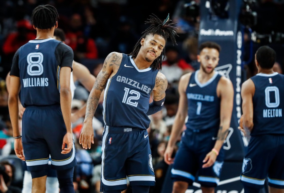 <strong>Grizzlies guard Ja Morant (middle) grabs his back in the game against the Minnesota Timberwolves on Thursday, Jan. 13, 2022.</strong> (Mark Weber/The Daily Memphian)