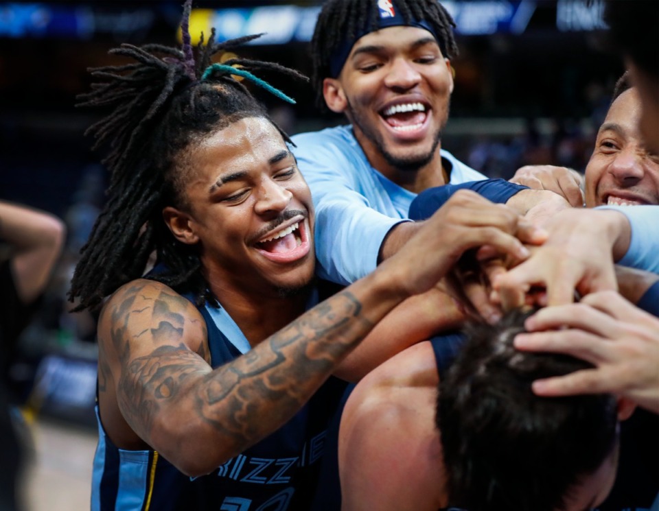 <strong>Grizzlies guard Ja Morant (left) and his teammates celebrate a 116-108 victory over the Minnesota Timberwolves on Thursday, Jan. 13, 2022.</strong> (Mark Weber/The Daily Memphian)
