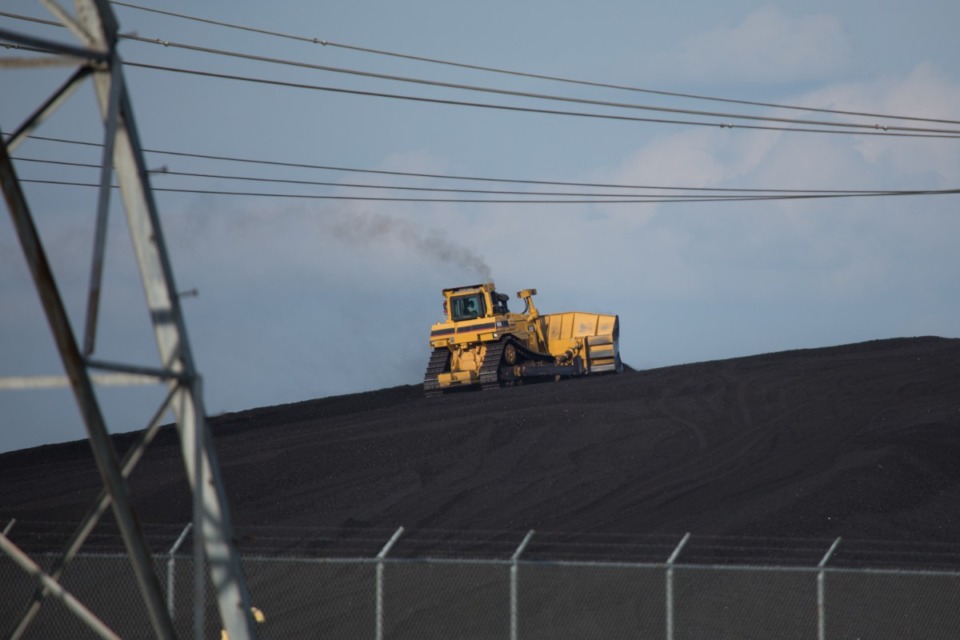 <strong>A bulldozer climbs the coal mound at&nbsp;the now-retired TVA Allen Fossil Plant.&nbsp;The TVA announced their plan to dispose of the coal ash in the South Shelby Landfill.</strong> (Daily Memphian, file)
