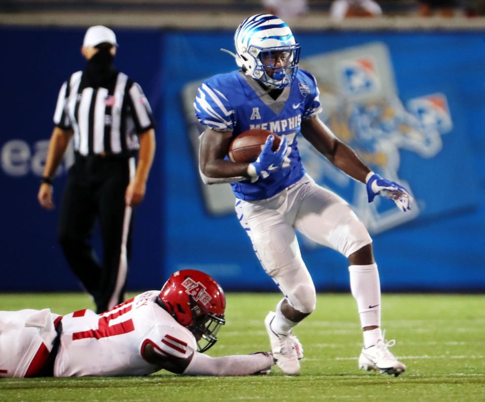 <strong>University of Memphis running back Kylan Watkins (17) breaks a tackle from Arkansas State linebacker Fred Harvey (24) on his way to a touchdown during the Tigers' home opener at Liberty Bowl Memorial Stadum, Sept. 5, 2020.</strong> (Patrick Lantrip/Daily Memphian file)