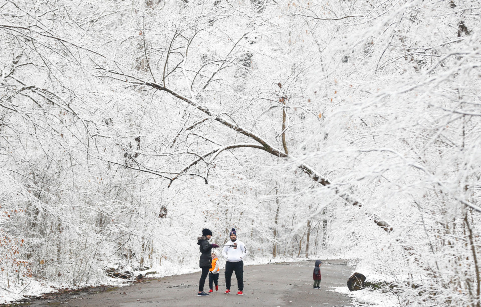<strong>Snow-covered trees create a picturesque backdrop for a family selfie in Overton Park Sunday, Jan. 16, 2022.</strong> (Mark Weber/The Daily Memphian)