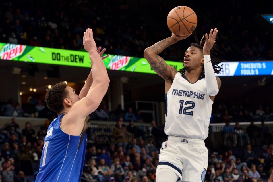 <strong>Memphis Grizzlies guard Ja Morant (12) shoots against Dallas Mavericks center Dwight Powell (7) in the first half of an NBA basketball game Friday, Jan. 14, 2022, in Memphis, Tennessee.</strong> (AP Photo/Brandon Dill)