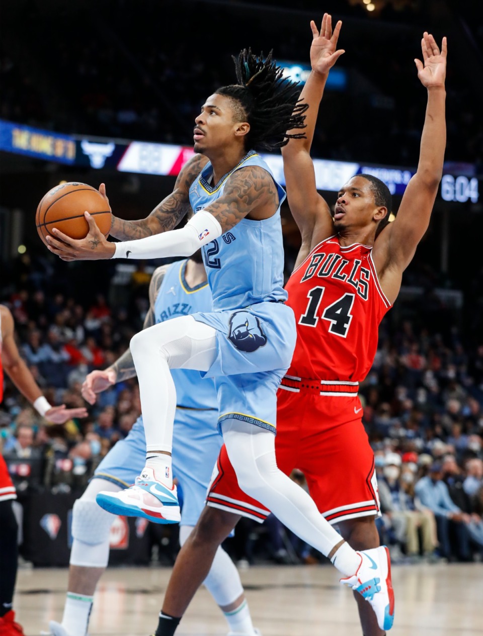 <strong>Memphis Grizzlies guard Ja Morant (left) drives for a layup against Chicago Bulls defender Malcolm Hill (right) during action on Monday, Jan. 17, 2022.</strong> (Mark Weber/The Daily Memphian)