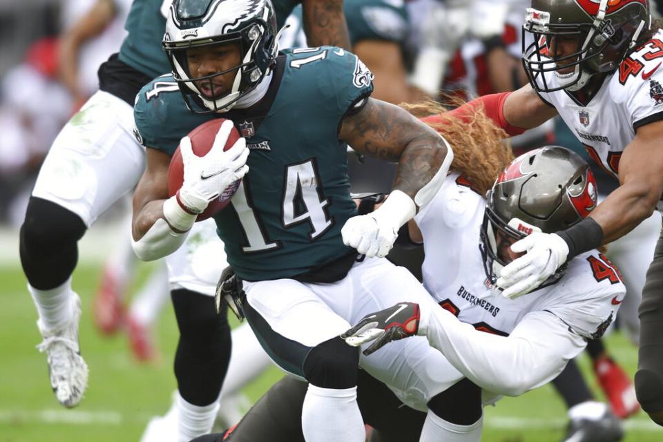 <strong>Philadelphia Eagles running back Kenneth Gainwell (14) is stopped by Tampa Bay Buccaneers linebacker Grant Stuard (48) during the first half of an NFL wild-card football game Sunday, Jan. 16, 2022, in Tampa, Florida. (AP Photo/Jason Behnken)</strong>