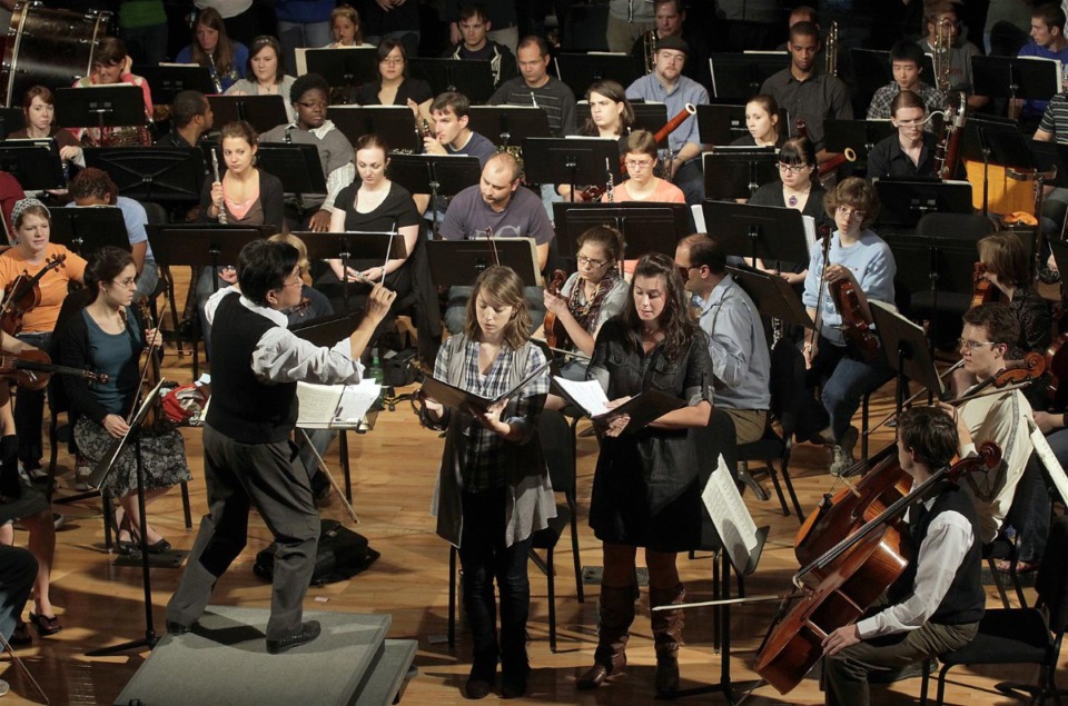 <strong>Maestro Pu-Qi Jiang conducts the University of Memphis Symphony Orchestra and the University Singers during a rehearsal for the 10th anniversary celebration of the Rudi E. Scheidt School of Music at the University of Memphis.</strong> (Daily Memphian file)