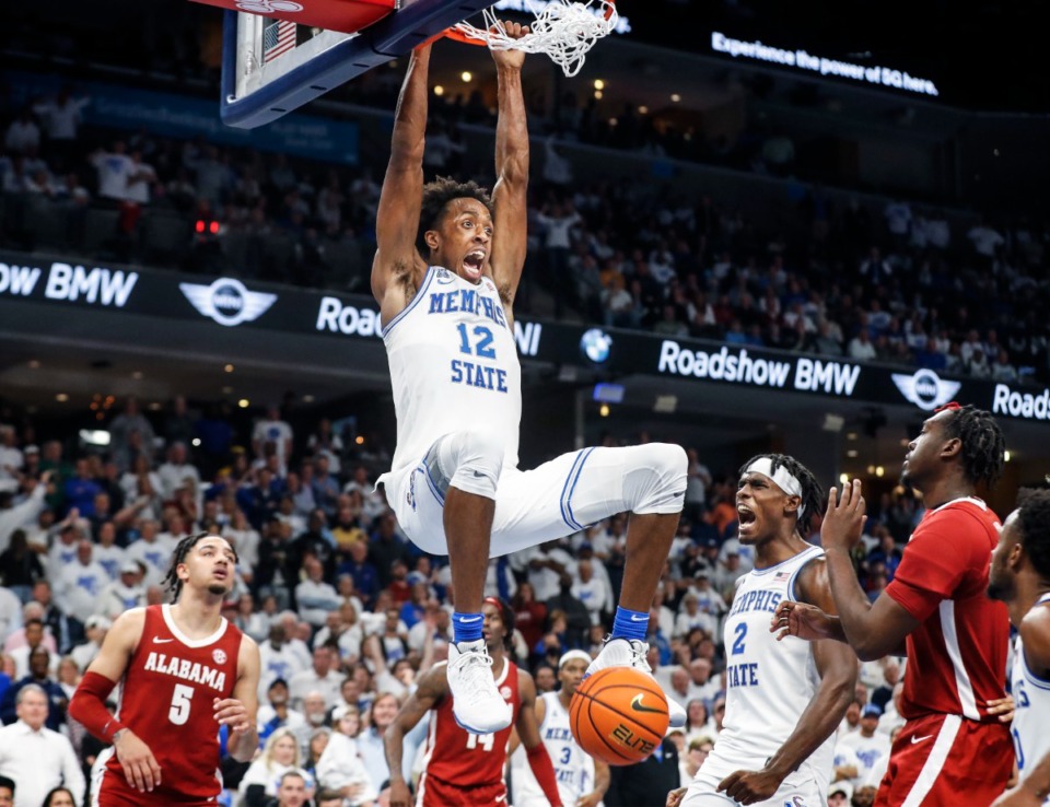 <strong>Memphis Tigers forward DeAndre Williams (top) celebrated a dunk against Alabama during action on Tuesday, Dec. 14, 2021.</strong> (Mark Weber/The Daily Memphian file)