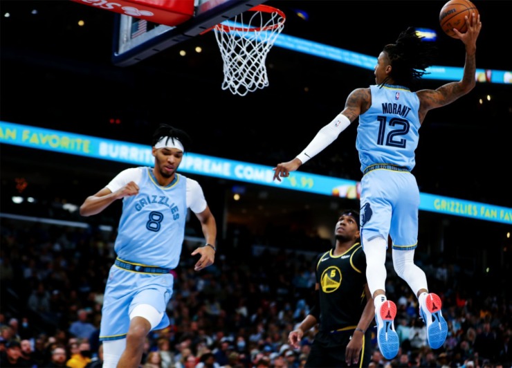 Memphis Grizzlies guard Ja Morant (12) throws down a dunk after a lob from Ziaire Williams (8) during a Jan. 11, 2022 game against the Golden State Warriors in Memphis, Tennessee. (Patrick Lantrip/Daily Memphian)