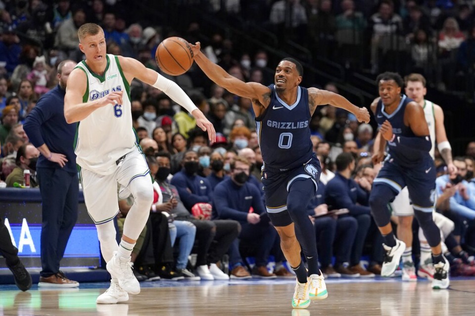 <strong>Dallas Mavericks center Kristaps Porzingis (6) gives chase as Memphis Grizzlies guard De'Anthony Melton (0) comes away with a steal in the first half of an NBA basketball game in Dallas, Sunday, Jan. 23, 2022.</strong> (AP Photo/Tony Gutierrez)