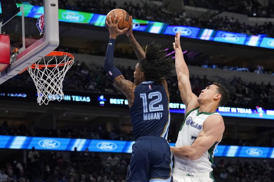 <strong>Memphis Grizzlies guard Ja Morant (12) goes up for a dunk after getting past Dallas Mavericks center Dwight Powell (7) in the first half of an NBA basketball game in Dallas, Sunday, Jan. 23, 2022.</strong> (AP Photo/Tony Gutierrez)