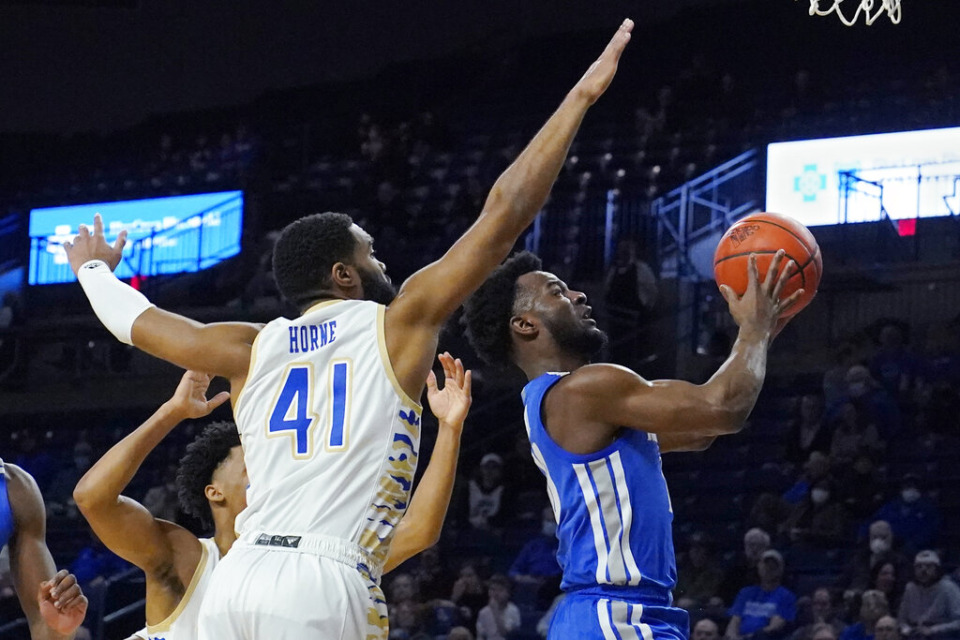 <strong>Memphis guard Alex Lomax, right, goes to the basket in front of Tulsa forward Jeriah Horne (41) in the first half of an NCAA college basketball game Sunday, Jan. 23, 2022, in Tulsa, Oklahoma.</strong> (AP Photo/Sue Ogrocki)