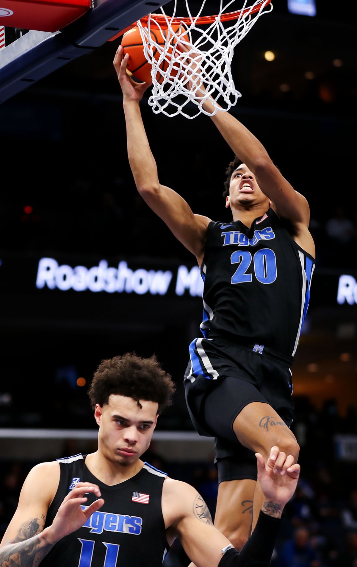 <strong>University of Memphis forward Josh Minott (20) goes up for a dunk on Jan. 27 as Lester Quinones (11) keeps up a screen against ECU.</strong> (Patrick Lantrip/Daily Memphian)