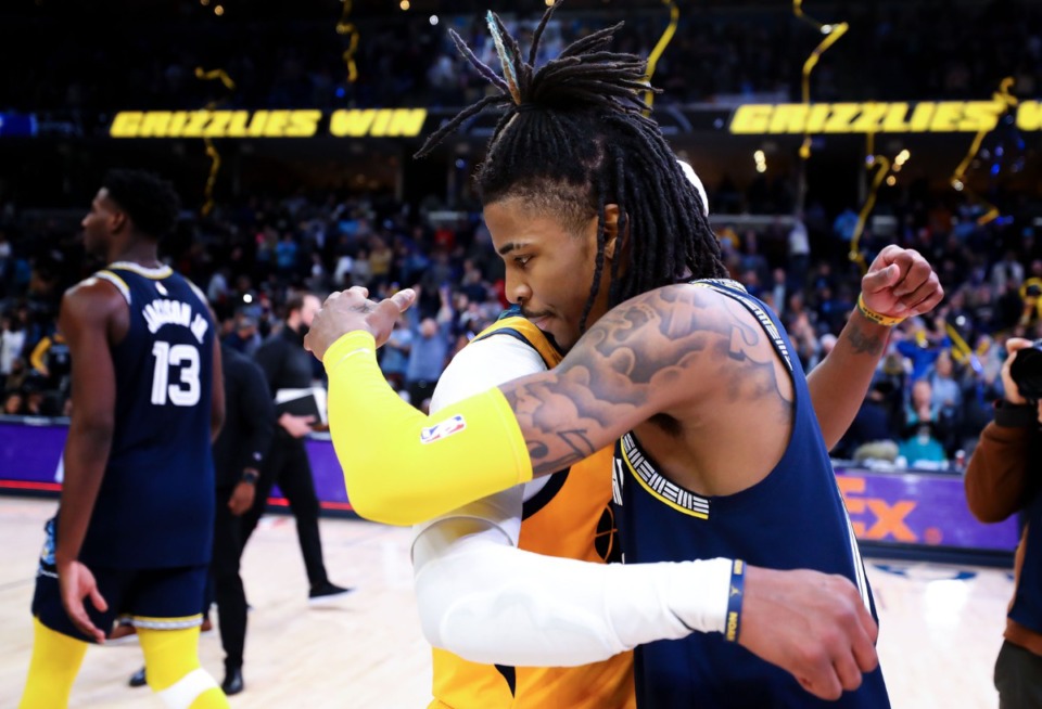 <strong>Memphis Grizzlies guard Ja Morant (12) hugs former Grizzly Mike Conley, now with the Utah Jazz, after the game on Jan. 28.</strong> (Patrick Lantrip/Daily Memphian)