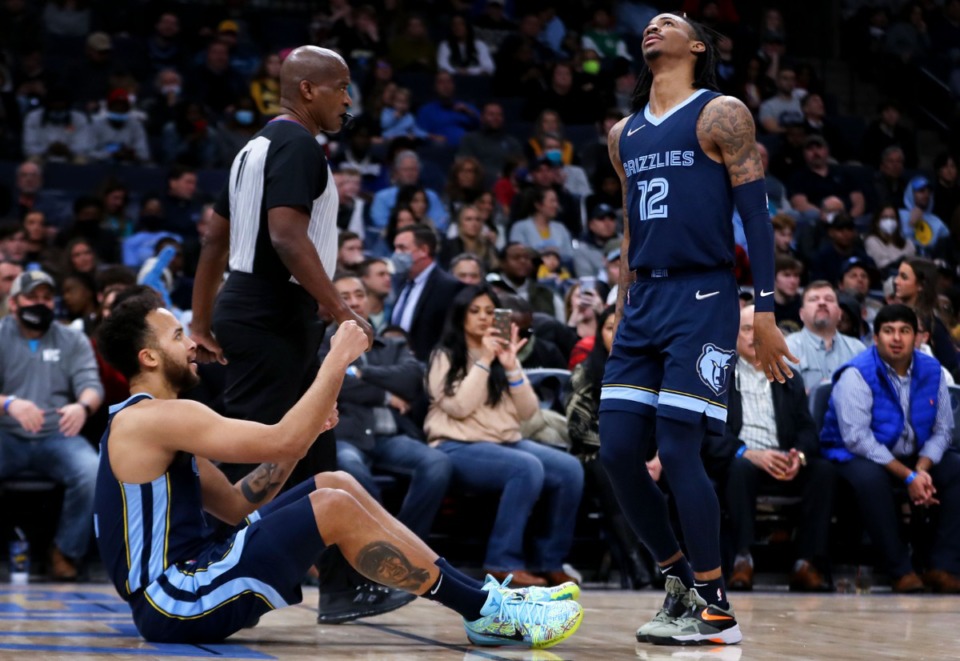 <strong>Memphis Grizzlies guard Ja Morant (12) dances while helping teammate Kyle Anderson up after a big play during a Jan. 29, 2022 game against the Washington Wizards.</strong> (Patrick Lantrip/Daily Memphian)