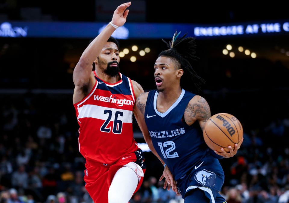 <strong>Memphis Grizzlies guard Ja Morant (12) drives to the basket against Washington Wizards guard Spencer Dinwiddie (26) during a Jan. 29, 2022 game at FedExForum.</strong> (Patrick Lantrip/Daily Memphian)