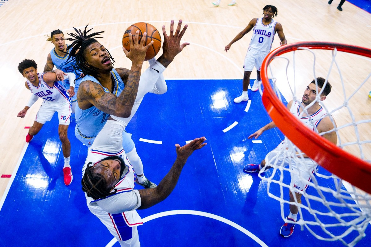 <strong>Memphis Grizzlies' Ja Morant, left, goes up for the shot against Philadelphia's Andre Drummond, center, on Jan. 31, 2022, in Philadelphia.</strong> (Chris Szagola/AP)