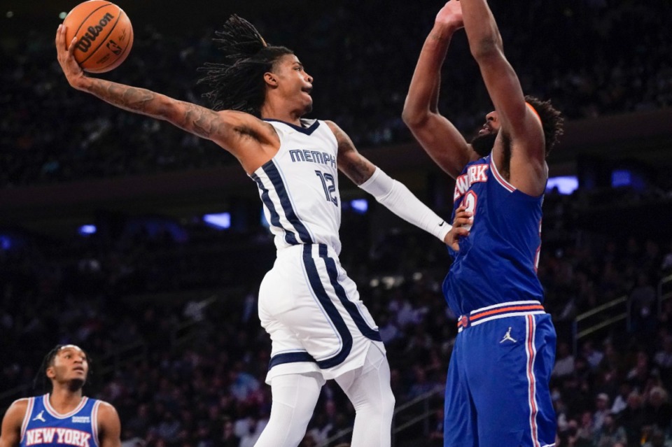 <strong>Grizzlies guard Ja Morant, left, is fouled by New York&rsquo;s Mitchell Robinson, right, as he goes up for a dunk on Feb. 2, 2022, in New York. The Grizzlies defeated the Knicks 120-108.</strong> (Seth Wenig/AP)