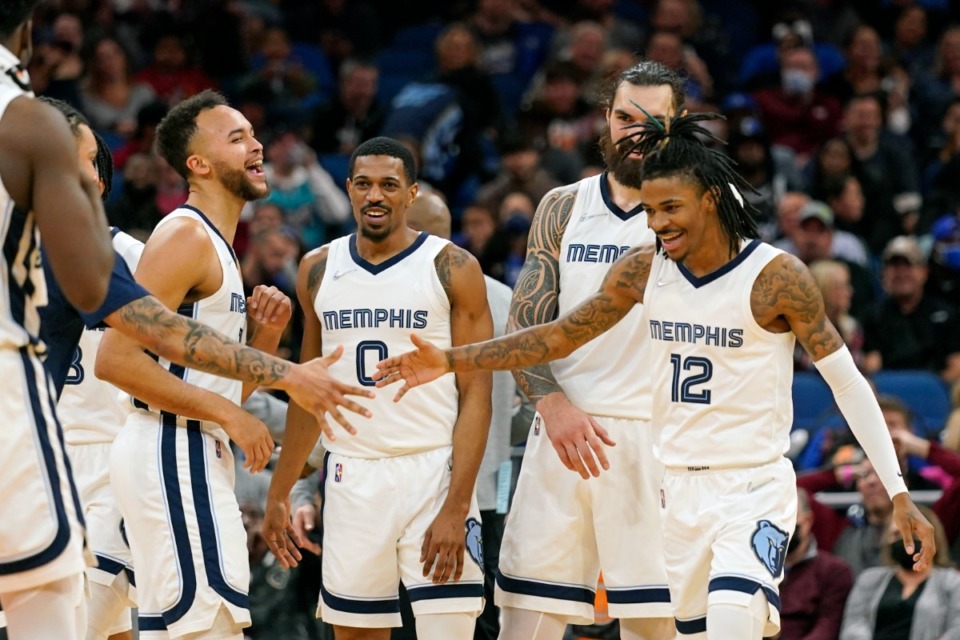 <strong>Memphis Grizzlies guard De'Anthony Melton (0) celebrates a big play against the Orlando Magic with teammates forward Kyle Anderson (left), center Steven Adams (second from right), and guard Ja Morant (12) during the second half of an NBA basketball game, Saturday, Feb. 5, 2022, in Orlando, Fla.</strong> (AP Photo/John Raoux)