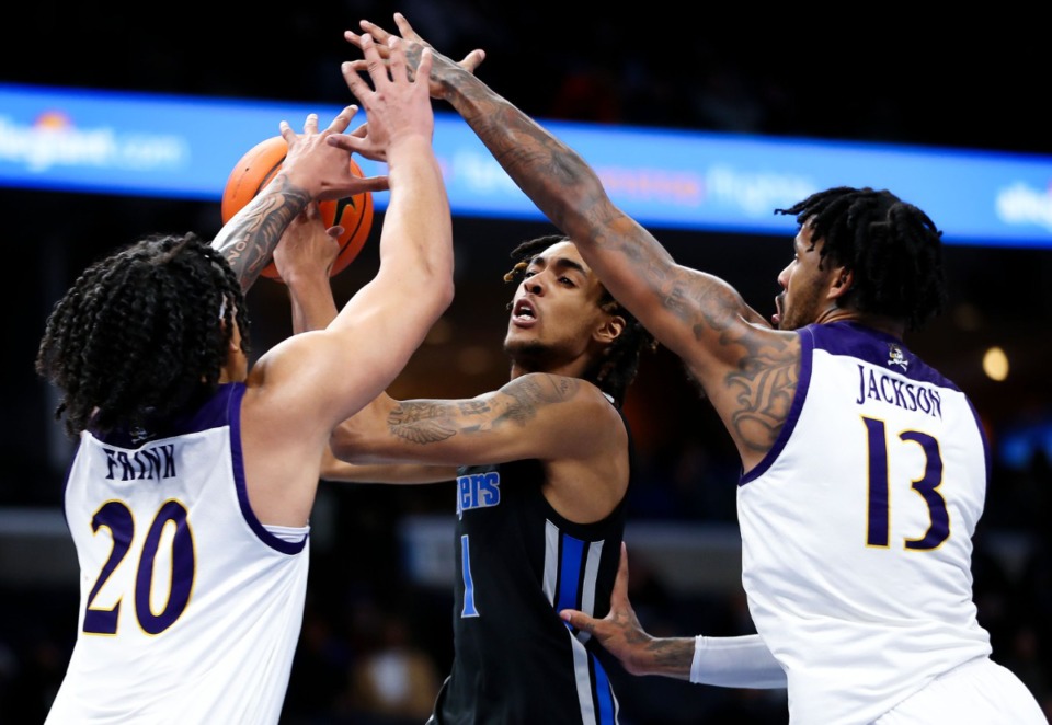 <strong>University of Memphis forward Emoni Bates (1) is bracketed by defenders on Jan. 27. Bates has returned to Memphis after seeing a specialist for his back injury.</strong> (Patrick Lantrip/Daily Memphian file)
