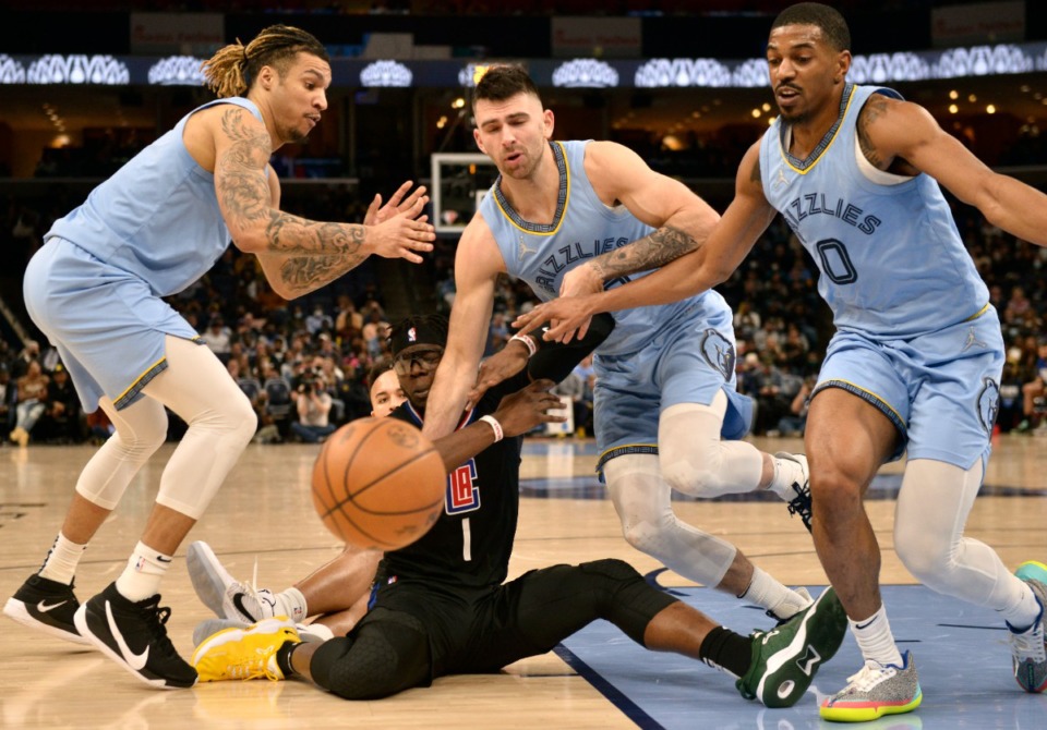 <strong>Memphis Grizzlies forward Brandon Clarke, from left, and guards John Konchar and De'Anthony Melton (0) move for position as Los Angeles Clippers guard Reggie Jackson (1) loses the ball on Feb. 8, 2022.</strong> (Brandon Dill/AP)