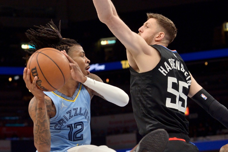 <strong>Memphis Grizzlies guard Ja Morant (12) is guarded by Los Angeles Clippers center Isaiah Hartenstein (55) as he tries to pass on Feb. 8 at FedExForum.</strong> (Brandon Dill/AP)