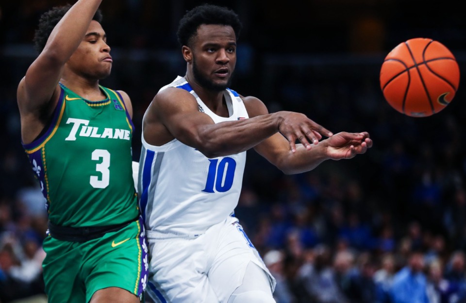 <strong>University of Memphis guard Alex Lomax (10) passes the ball on Feb. 9 in the game against Tulane.</strong> (Patrick Lantrip/Daily Memphian)