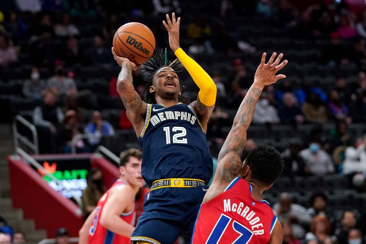 <strong>Grizzlies guard Ja Morant (12) shoots over Detroit Pistons guard Rodney McGruder (17) on Feb. 10 in Detroit.</strong> (Paul Sancya/AP)