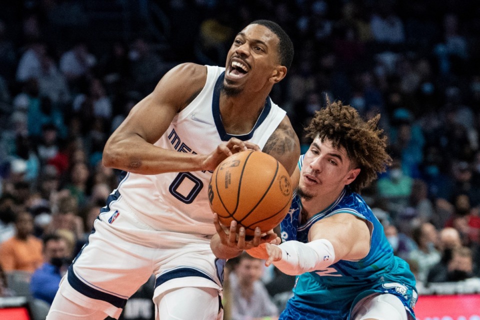 <strong>Charlotte Hornets guard LaMelo Ball (2) tries to knock the ball away from Memphis Grizzlies guard De'Anthony Melton (0) during the first half of an NBA basketball game in Charlotte, N.C., Saturday, Feb. 12, 2022.</strong> (AP Photo/Jacob Kupferman)