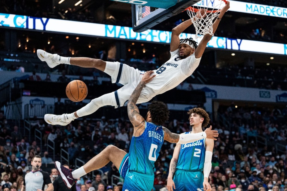 <strong>Memphis Grizzlies guard Ziaire Williams (8) dunks the ball and is fouled by Charlotte Hornets forward Miles Bridges (0) during the first half of an NBA basketball game in Charlotte, N.C., Saturday, Feb. 12, 2022.</strong> (AP Photo/Jacob Kupferman)
