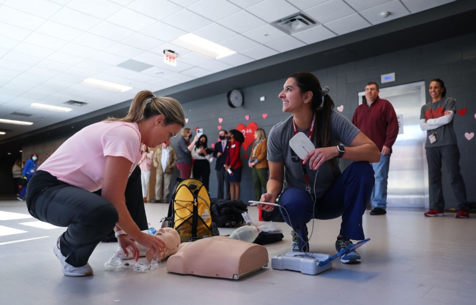 <strong>Jaimee Lapham and Jenna Connelly (right) take apart the practice dummy after a cardiac arrest drill at Collierville High School in front of a group of certifying doctors from Le Bonheur Children's Hospital Feb. 14, 2022.</strong>(Patrick Lantrip/Daily Memphian)