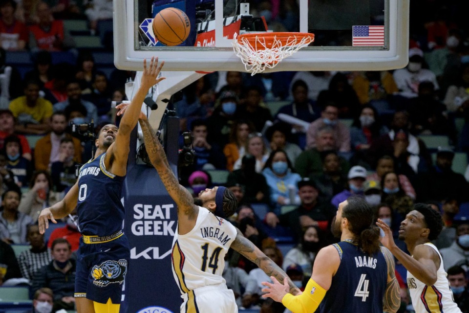 <strong>Memphis Grizzlies guard De'Anthony Melton (0) shoots against New Orleans Pelicans forward Brandon Ingram (14) during the first half of an NBA basketball game in New Orleans, Tuesday, Feb. 15, 2022.</strong> (AP Photo/Matthew Hinton)