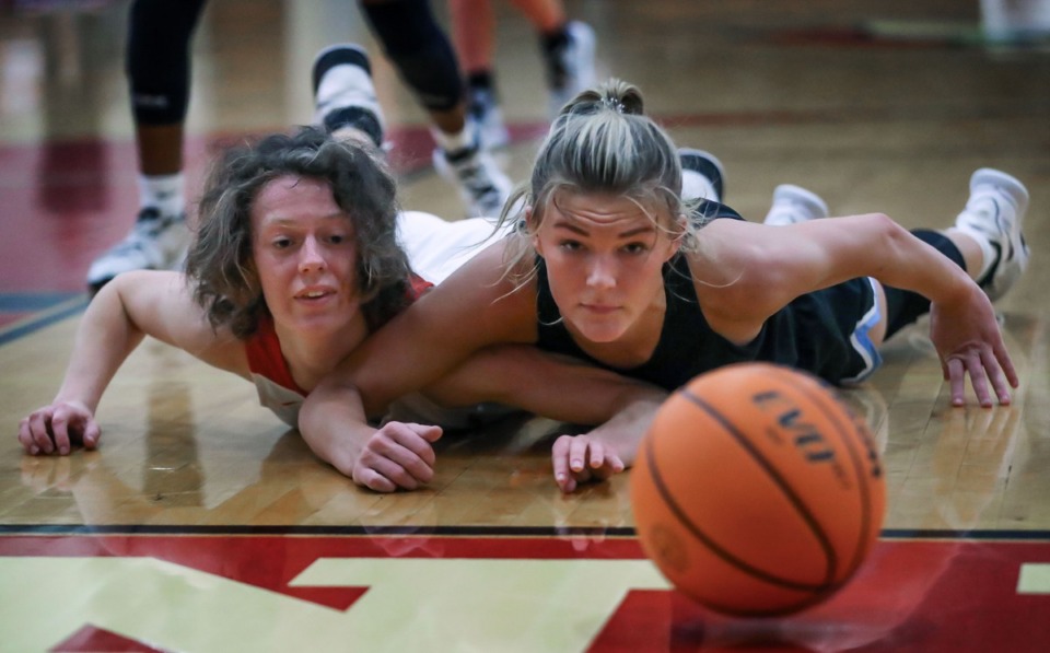 <strong>Northpoint Christian School's Brylee Faith Cherry (15) and Fayette Academy's Megan Grantham (13) dive for a loose ball as it rolls out of bounds in a regional semifinal match on Feb. 17, 2022.</strong> (Patrick Lantrip/Daily Memphian)