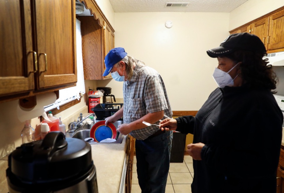 <strong>SRVS resident Glen Nichols (left) cleans dishes with the help of independent coach Sheila Clark. Nichols lives in the first SRVS home to have Remote Monitoring.</strong>&nbsp;<strong>&ldquo;We do check in on the residents and monitor their movements,&rdquo; Clark said.&nbsp;</strong>(Mark Weber/The Daily Memphian)