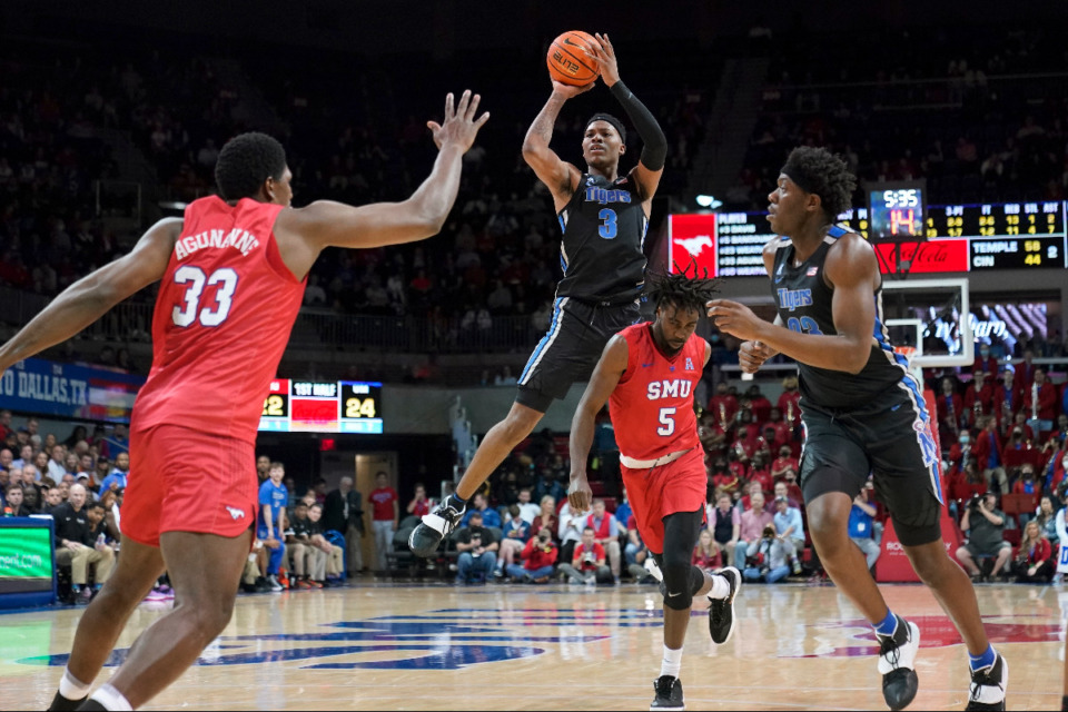 <strong>SMU's Franklin Agunanne (33) and Emmanuel Bandoumel (5) defend against a shot by Memphis guard Landers Nolley II (3) in the first half of an NCAA college basketball game in Dallas, Sunday, Feb. 20, 2022.</strong> (AP Photo/Tony Gutierrez)