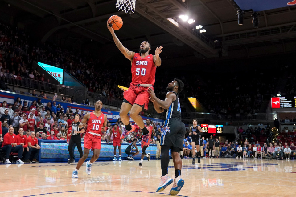 <strong>SMU forward Marcus Weathers (50) leaps to the basket for a shot after getting past Memphis guard Alex Lomax, right, in the second half of an NCAA college basketball game in Dallas, Sunday, Feb. 20, 2022.</strong> (AP Photo/Tony Gutierrez)