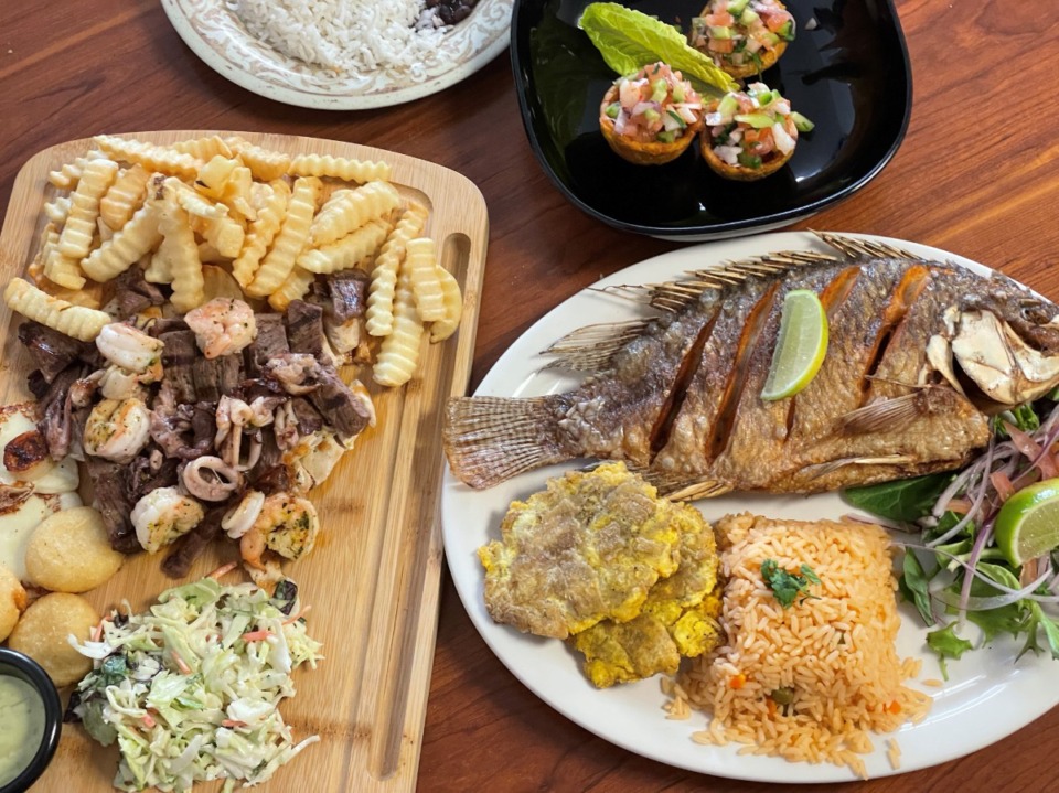 <strong>The parrilla mar y tierra is a platter of beef, chicken, shrimp and calamari with fries, arepas, grilled cheese, slaw, and beans and rice. An order of pescado frito delivers a huge whole tilapia at Cevicheria and Grille Chilemon.</strong> (Jennifer Biggs/The Daily Memphian)