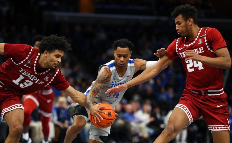 <strong>University of Memphis guard Tyler Harris (14) dribbles through two defenders on Feb. 24 in the game against Temple at FedExForum.</strong> (Patrick Lantrip/Daily Memphian)